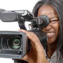 A Black female filmmaker working with her camera