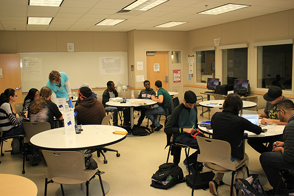 Students in the tutorial center sitting around table