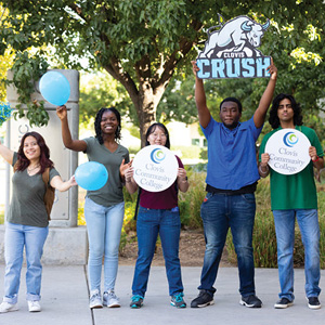 Students holding up a Clovis Crush sign and balloons