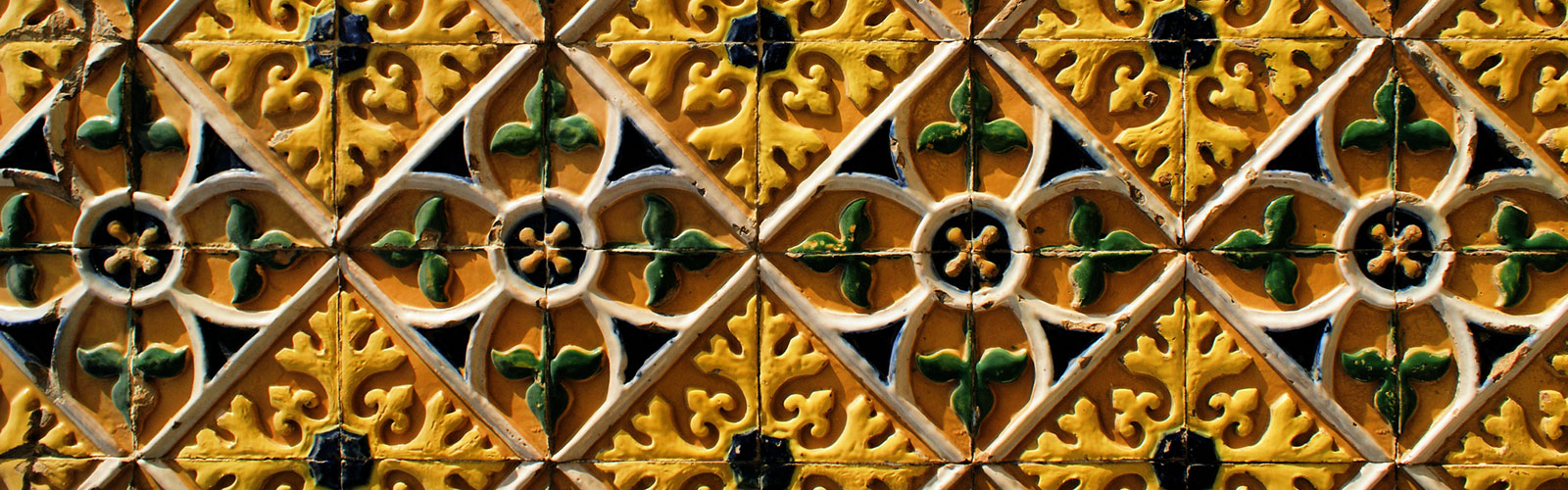 A yellow, green, and brown tile wall 