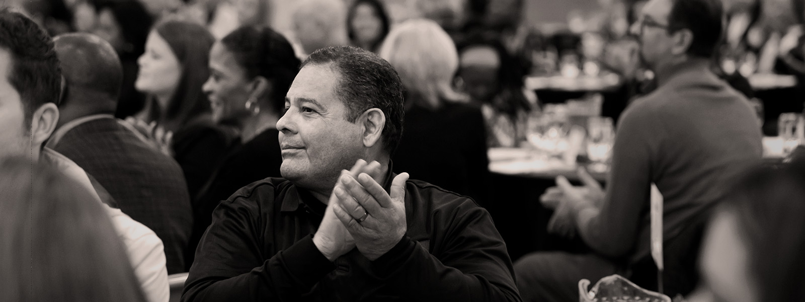 A well dressed man clapping