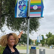 President Dr. Kim Armstrong points to new DEIA signage