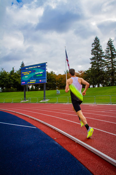 shot of CJ Albertson running with view of score board