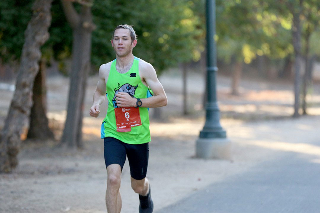 Coach Albertson wearing a clovis Crush running top while racing.