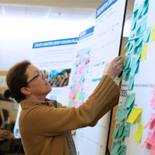 Clovis Community College employees post notes on a ideas board