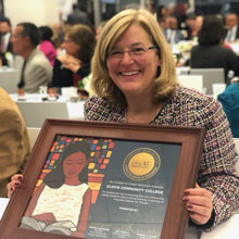 Dr Bennett holding the award