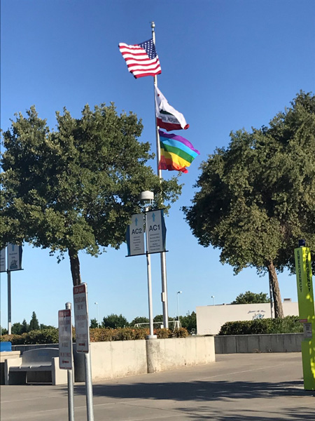 Pride Flag flying with American flag and California Flag