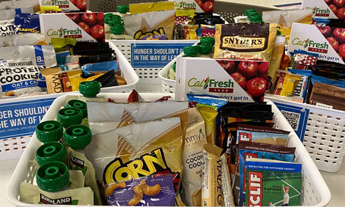 Snack station baskets: cliff bars, corn nuts, apple sauce, cookies, granola bars