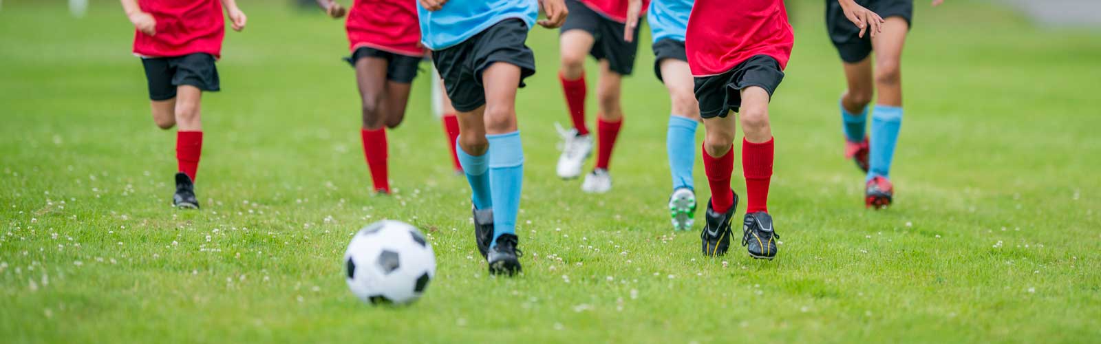 young soccer players chasing the ball