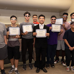 students holding award certificates