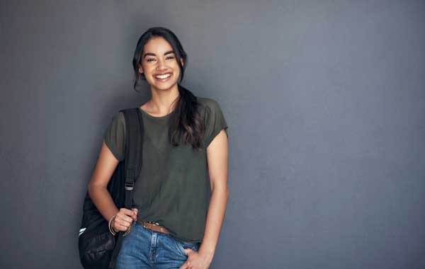 Young female student in jeans and a t-shirt, smiling