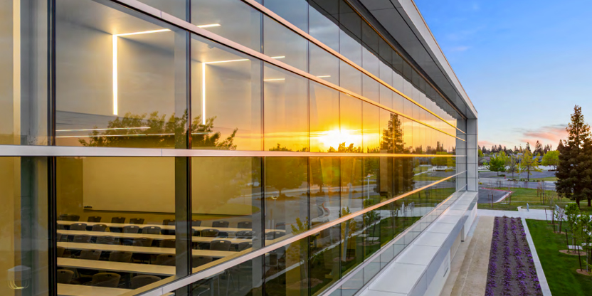 Side angle of the AC3 building at dusk
