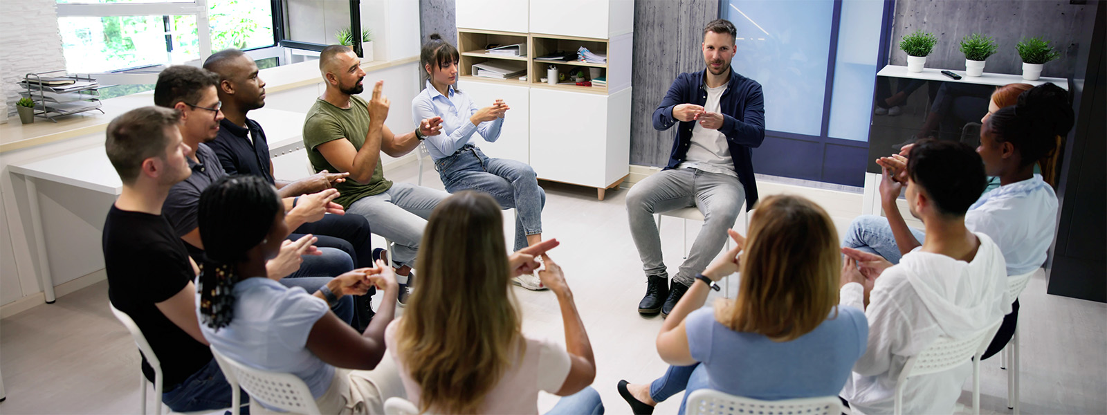 A group of people using sign language