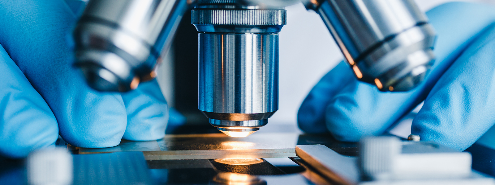 Close up of someone using a microscope