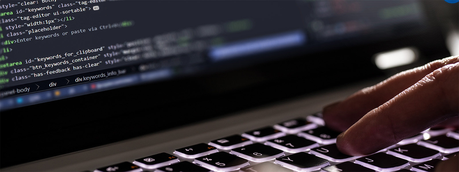 Someone programming on their laptop at night