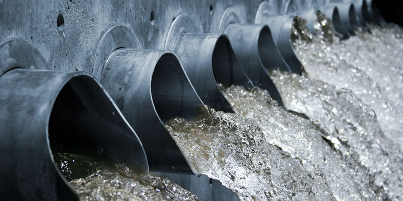 Water gushing out of steel spouts, high shutter speed, shallow depth of field