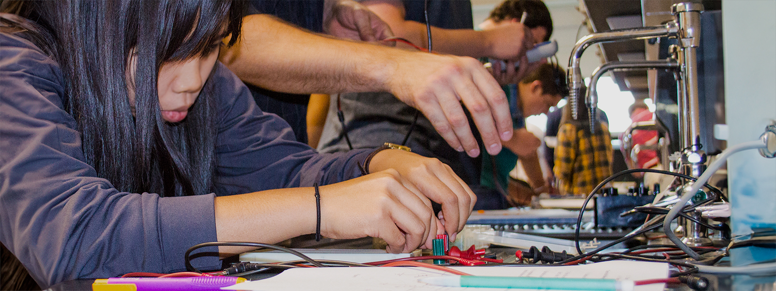 Students in an electrical engineering class, wiring electronics