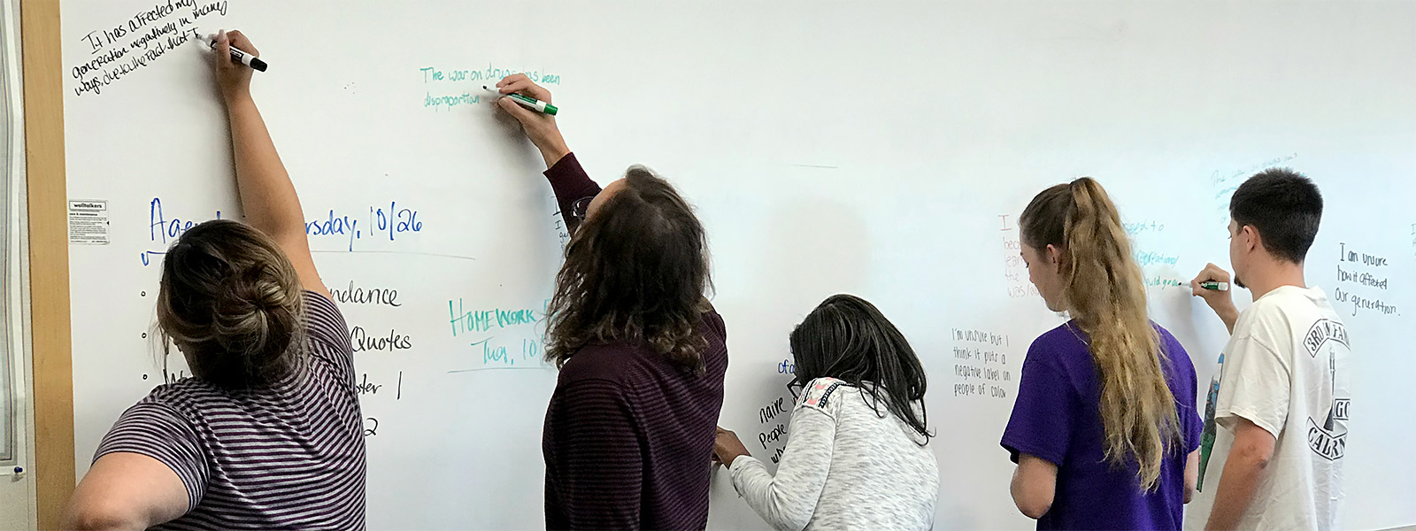 Students writing on the board