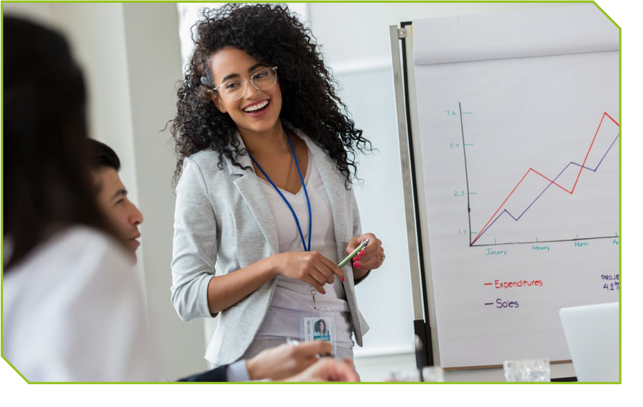 An African American female standing at a whiteboard while engaging with students