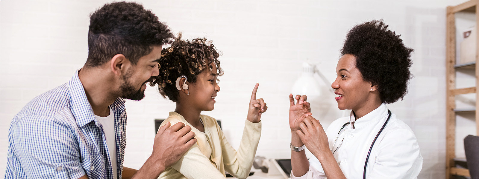 People using sign language in a doctor's office