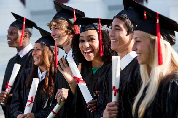 A group of high school students celebrating high school graduation