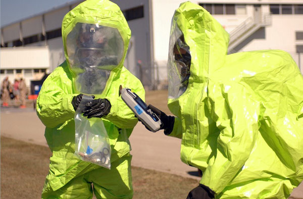 hazard workers in full hazard suits