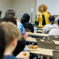 Dr. Kim Armstrong talks to a group of a students