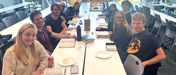 Bible Club eating together with open Bibles