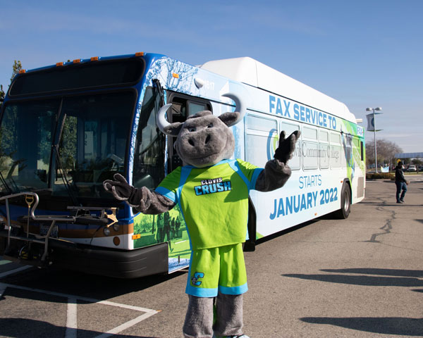 Crush mascot posing with FAX Bus