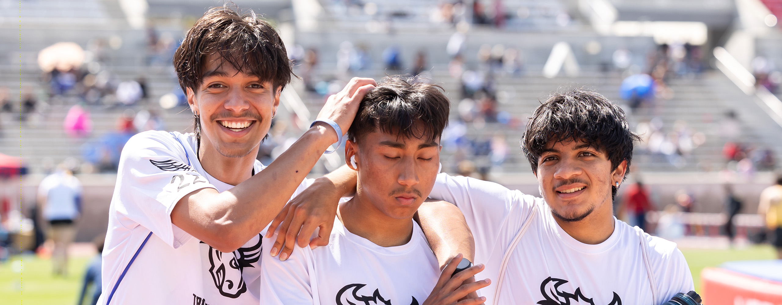 track and field athletes supporting their teammate