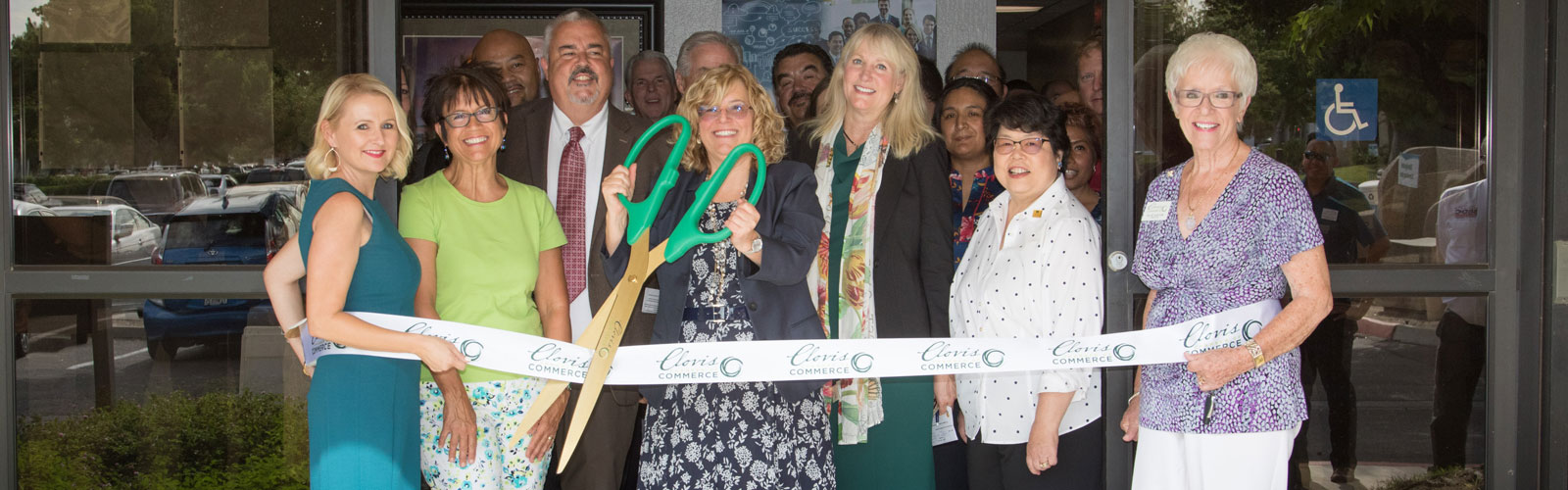 Dr. Bennet cutting the ribbon and the SBDC Ribbon Cutting event