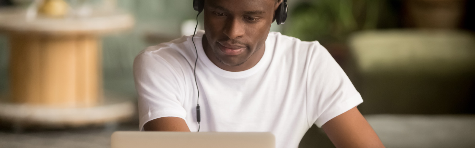 African American male student working on a laptop