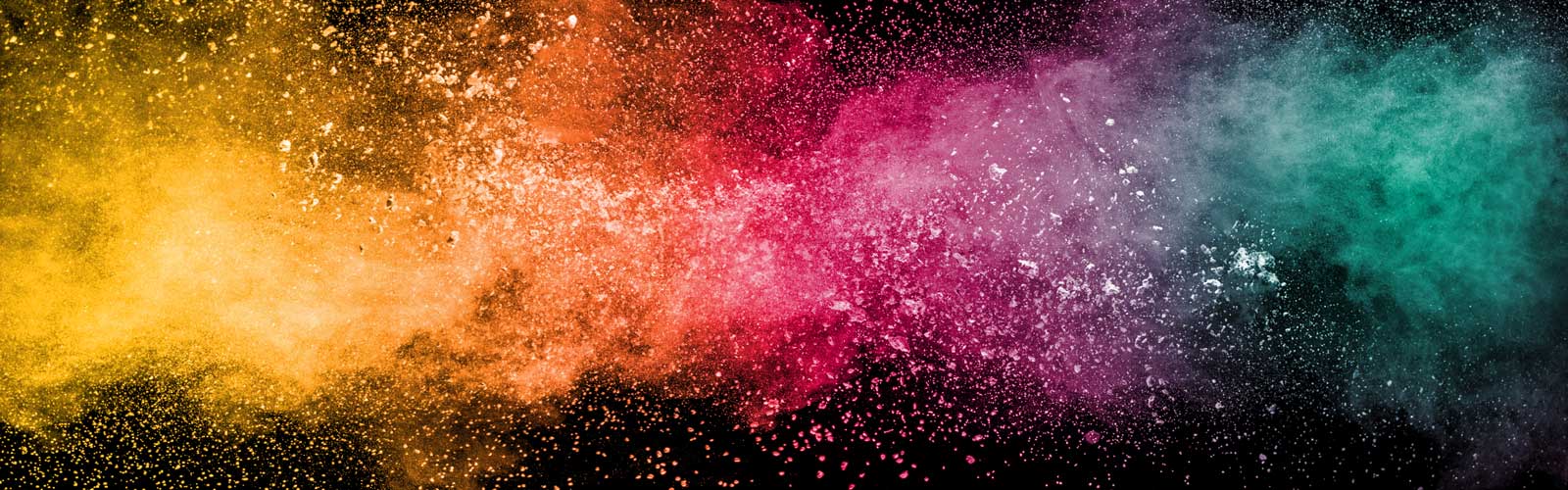 Colorful background of pastel powder explosion.Rainbow color dust splash on black background