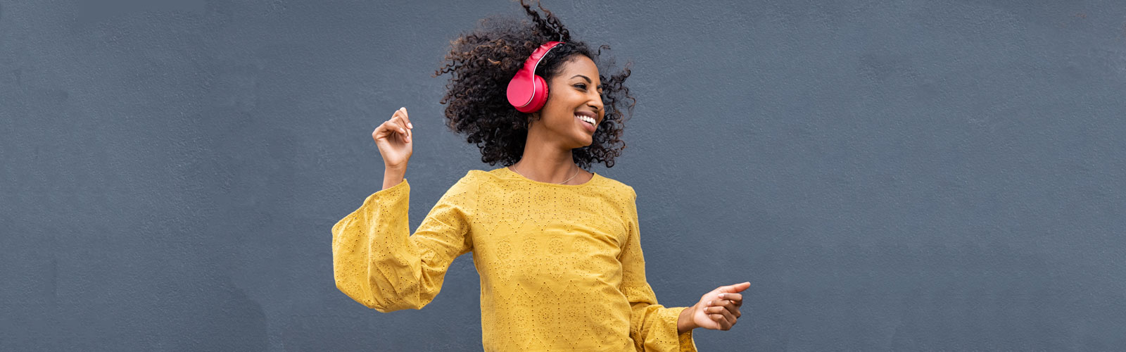 student dancing to music while wearing headphones