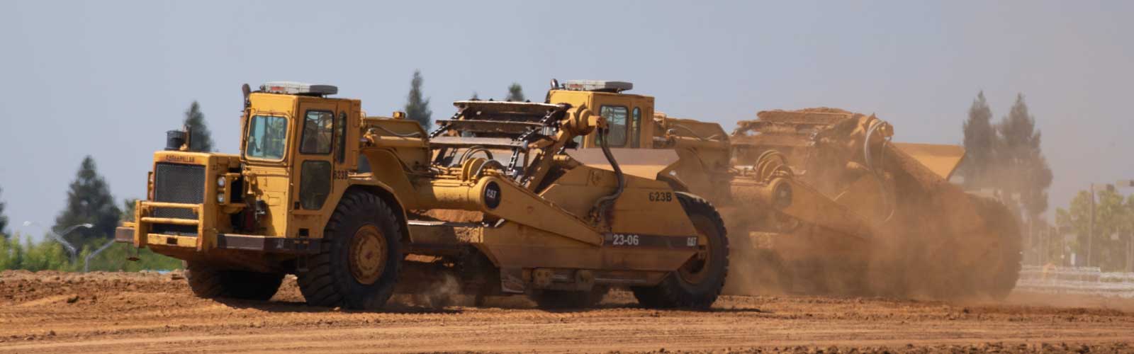 A big yellow digger at work during the groundbreaking