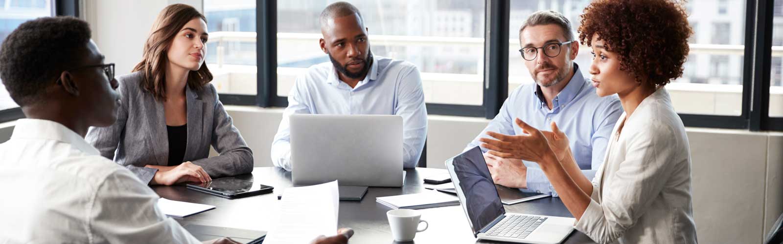 A diverse group of professionals sitting around a table and having a discussion