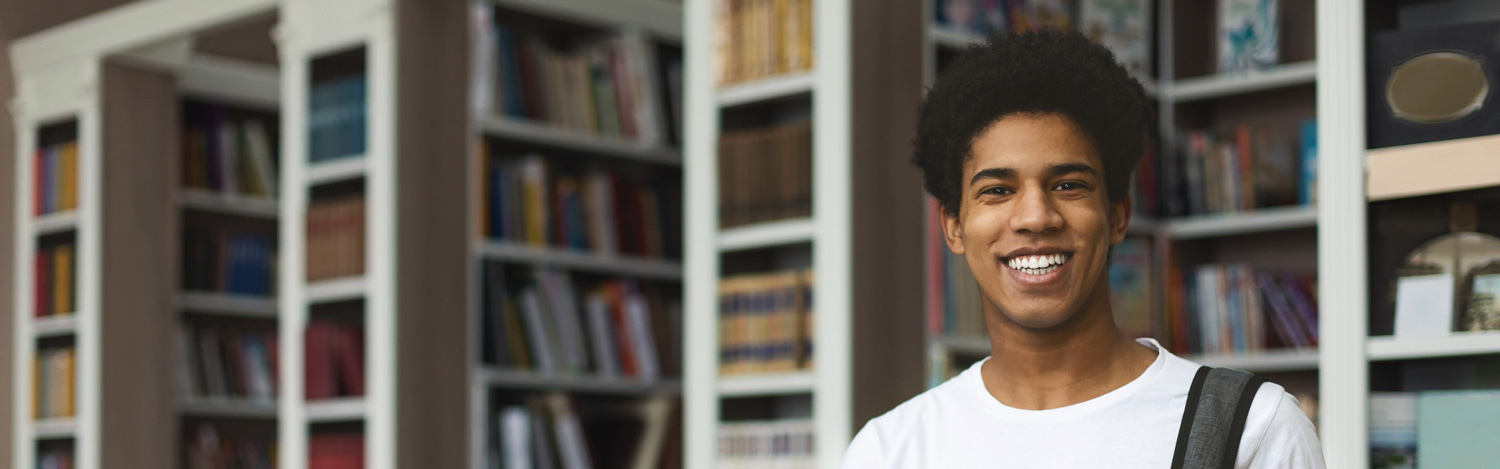 Handsome african american male student posing in campus library