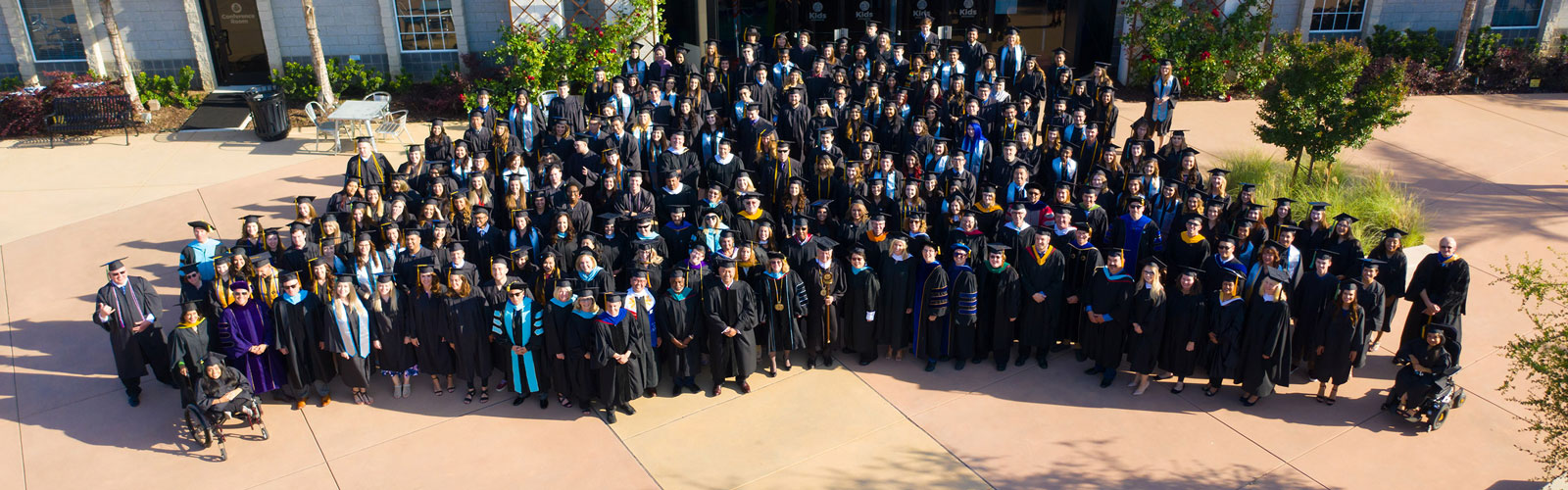Large group photo of students and staff at Graduation
