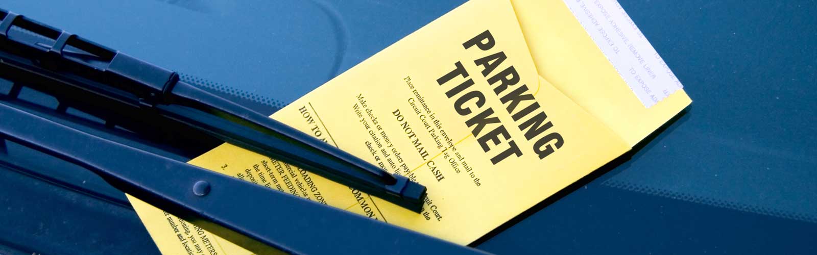 Parking ticket on car windshield