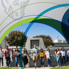 Students standing in front of the Clovis Community College Campus Sign 