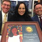 Staff members holding the framed award