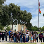Flag raising ceremony. Students and staff in group photo