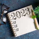 decorative thumbnail: glasses, journal written 2023, plant