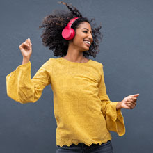 student dancing to music while wearing headphones