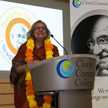 Ms. Ela Gandhi standing at the podium