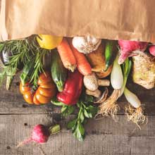 A paper bag full of fresh, healthy food