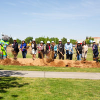 Leadership and community members breaking ground with shovels