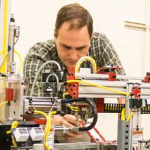 Mechatronics teacher, Mathew Graff, working on a mechatronics project