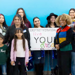 President Dr. Kim Armstrong in a group photo with young children