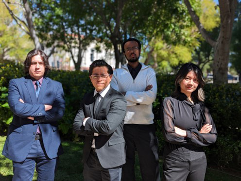 Speech and Debate Club members posing outside with arms folded